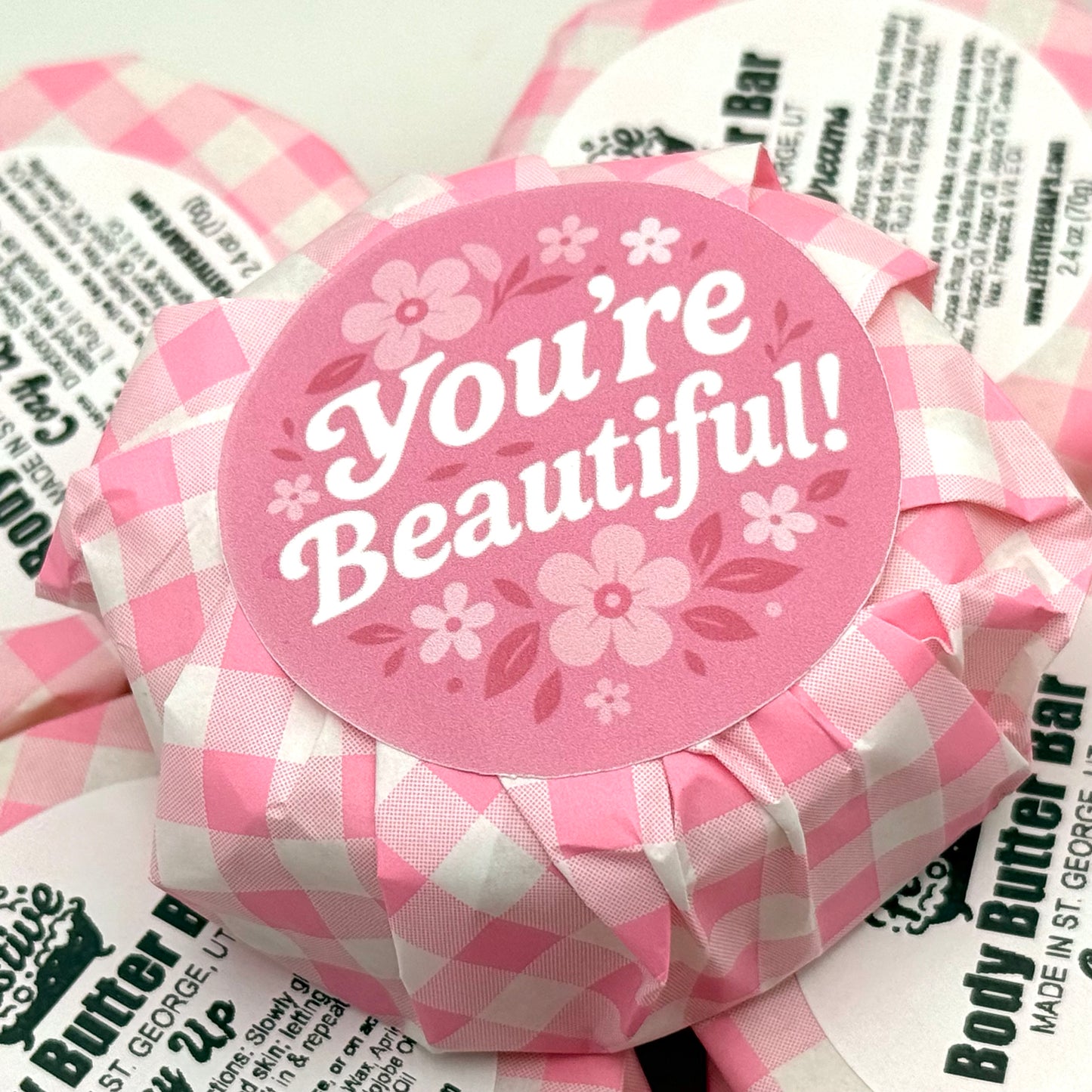 Pink checkered wrapper with 'You're Beautiful!' label on the back side of the wrapper.