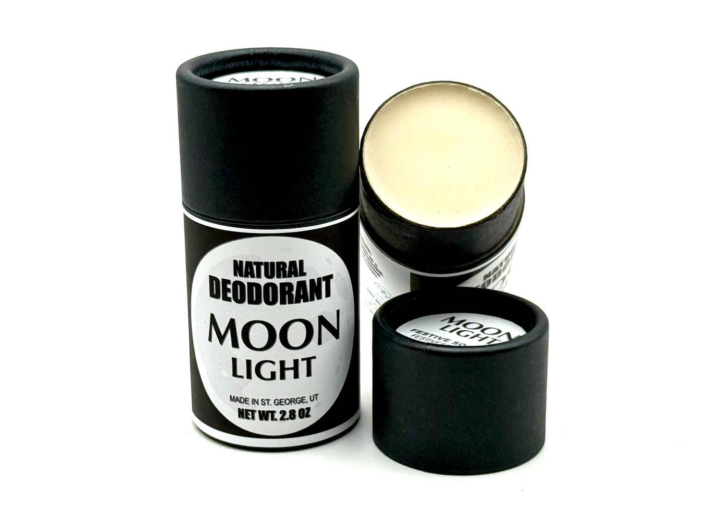Moon Light natural deodorant stick with packaging on a white background. One of the tubes has it's lid off so you can see the creamy deodorant inside.