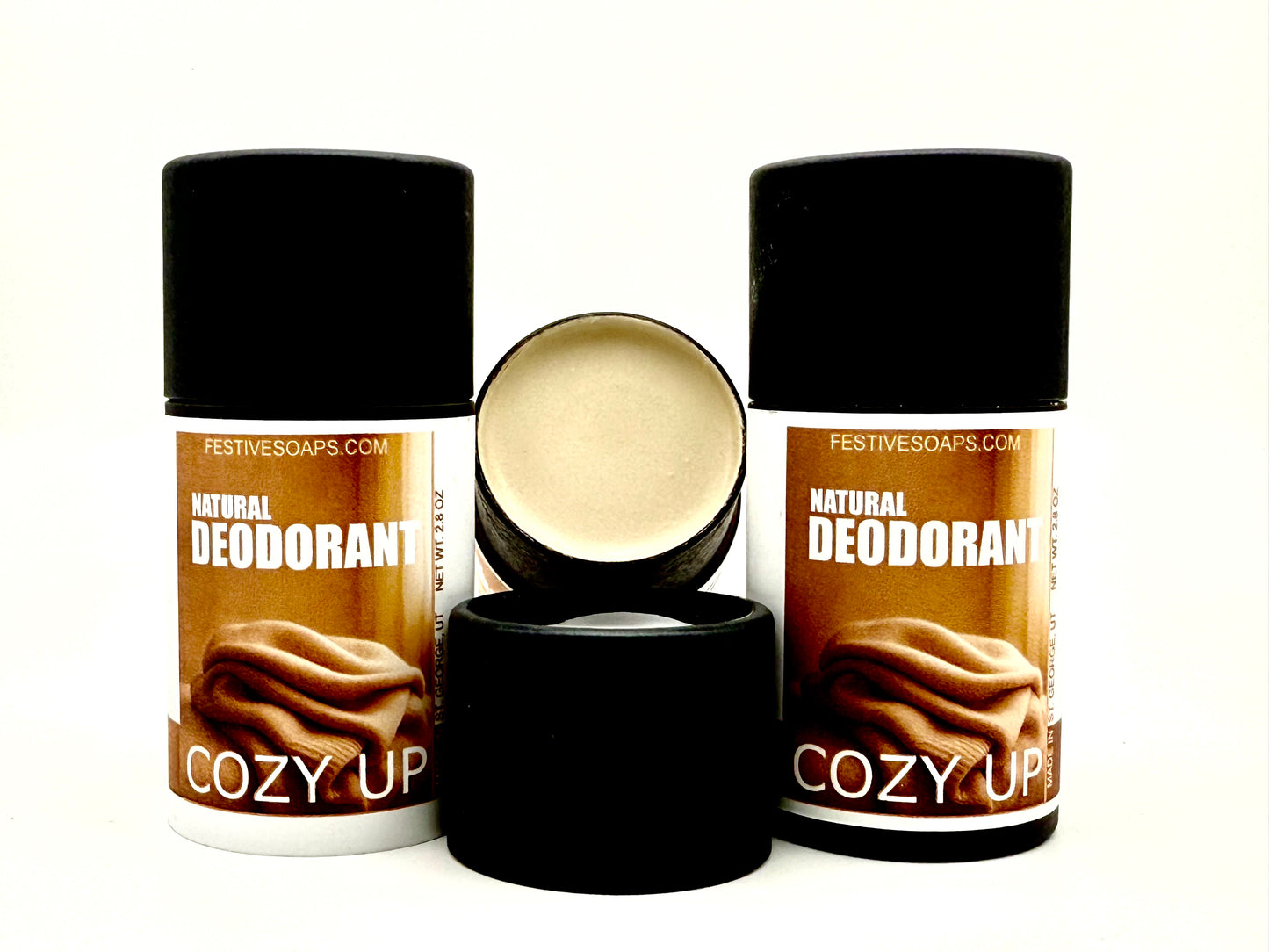 3 tubes of 'Cozy Up' natural deodorant from Festive Soaps on a white background