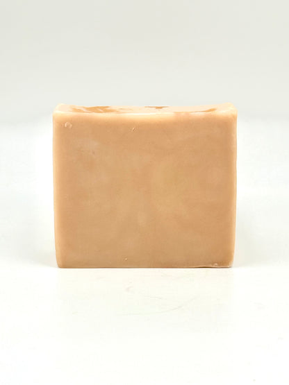 naked bar of beige soap on a white background 
