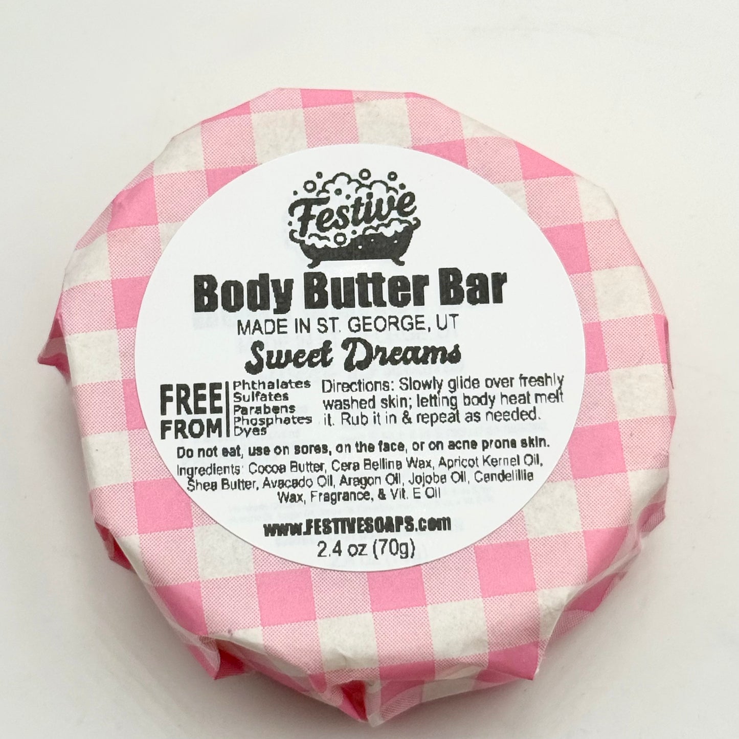 Body butter bar with pink and white checkered wrapper on a white background