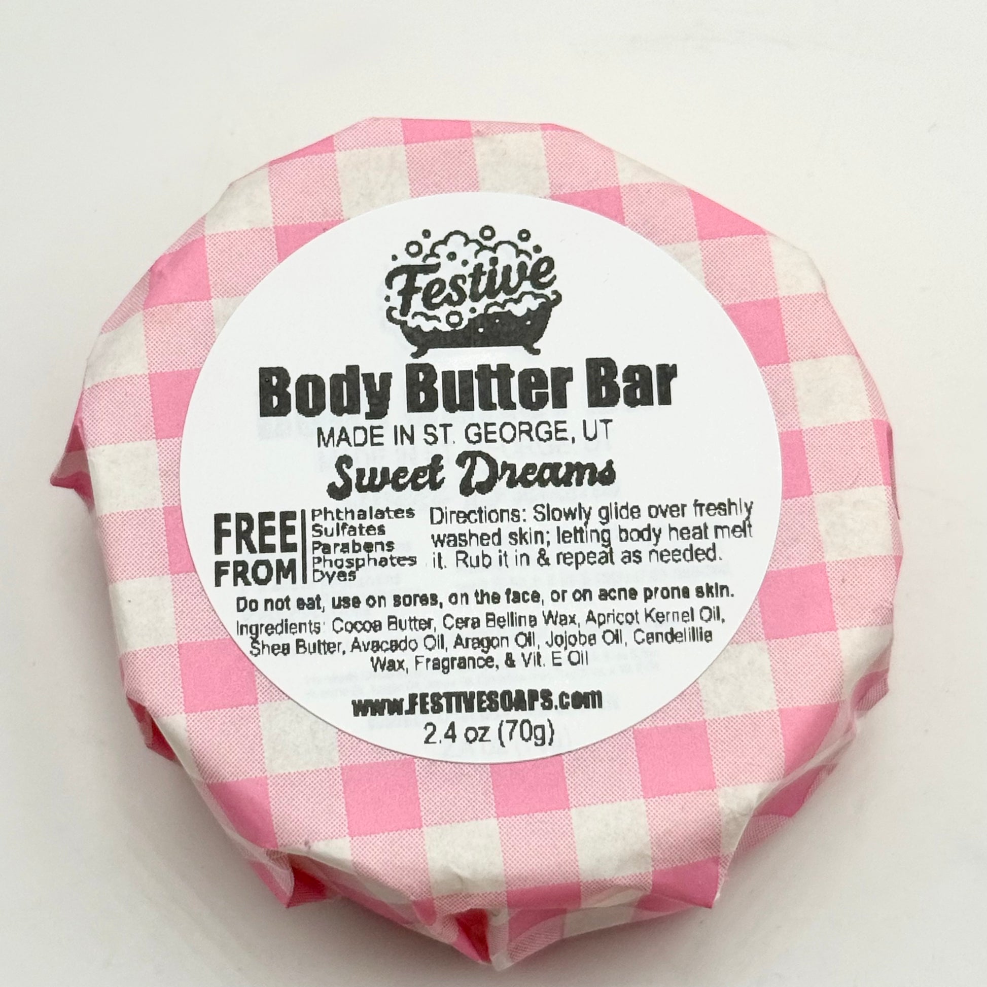 Body butter bar with pink and white checkered wrapper on a white background