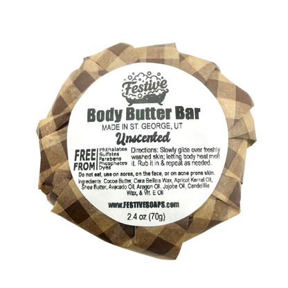 Body butter bar with a checkered wrapper and white label on a white background