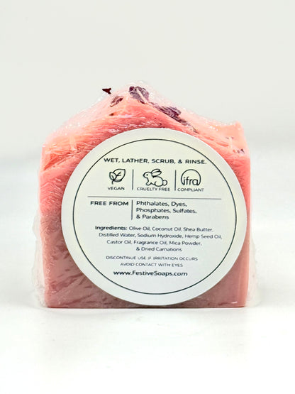 Pink soap bar with a white label on a white background