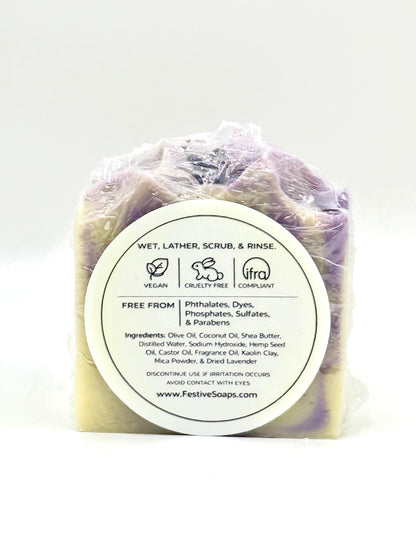 Bar of soap in clear plastic wrap with a label on a white background