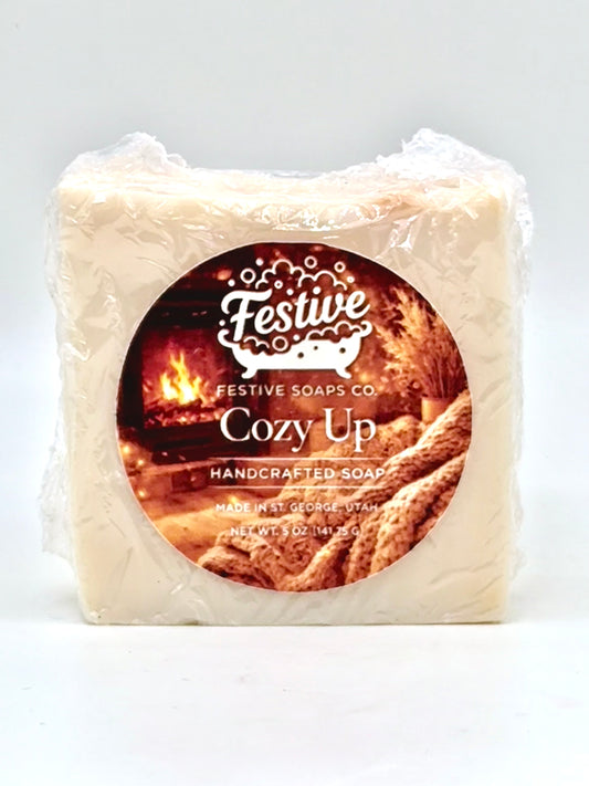 Handcrafted soap bar with 'Festive Soaps Co' label on a white background