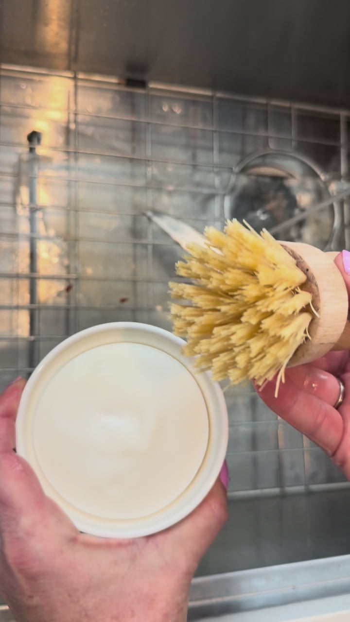 video showing some dishes being scrubbed with the dish soap set